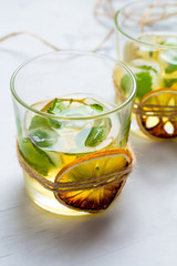 Cocktail of whiskey and citrus with ice.