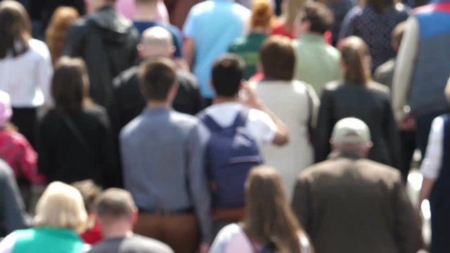 Slow motion footage with blur of thick crowd of people.