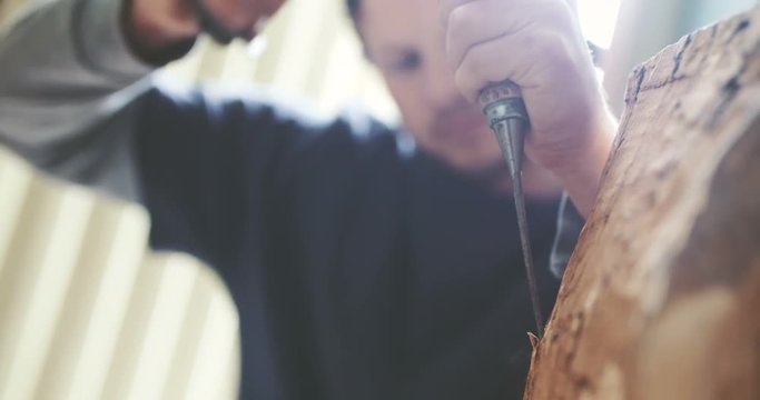 Young Carpenter Shaping Wood With Chisel