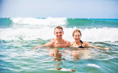 Happy young couple enjoying the sea
