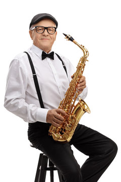Mature jazz musician with a saxophone sitting on a chair