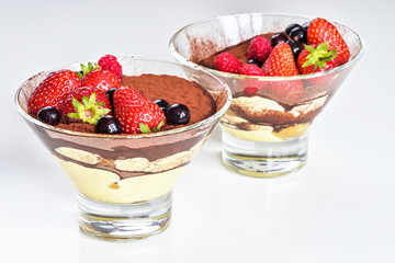 Homemade tiramisu with berries on white background