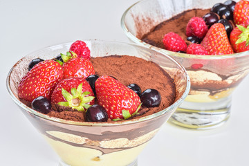 Homemade tiramisu with berries on white background