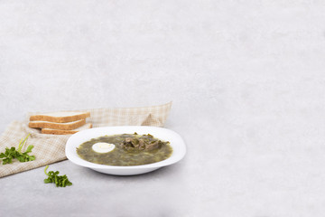 Soup of sorrel and young greens with egg