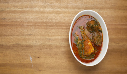 A bowl of ewedu and gbegiri mixed with beef and fish condiments