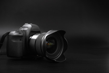  camera with lens on a black background. Canon is the world's largest SLR camera manufacturer.