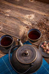 Iron teapot and cups of tea