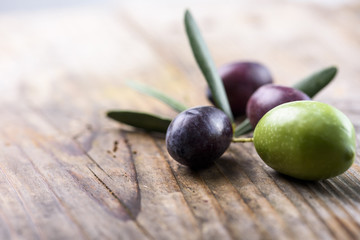 Olive fruit on wooden table