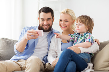 happy family with smartphone at home