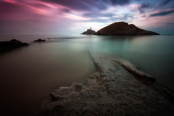 A calm full tide evening at Mumbles Lighthouse in Swansea Bay, UK.