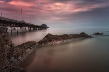 Fototapeta premium A calm full tide evening at Mumbles Pier, showing new lifeboat station, Swansea, South Wales, UK