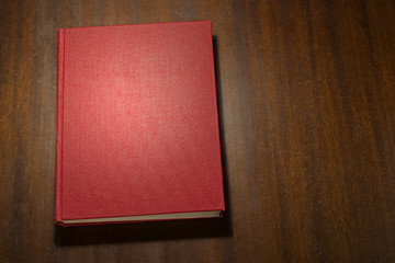 Red book on the wooden scratched table - 151508356