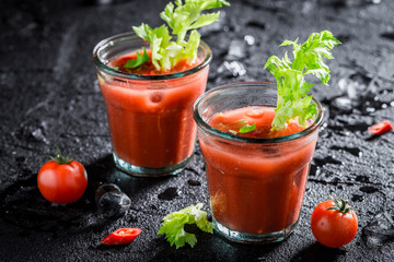 Spicy bloody mary cocktail with tomatoes and ice