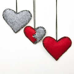 Three felt heart on a white background, valentines composition, copy space