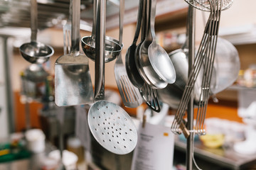 Close up of utensils hanging in kitchen