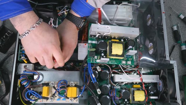 Timelapse. Engineer assembling electrical equipment. 4K.