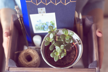 box with an handmade notebook, a string, in  hands