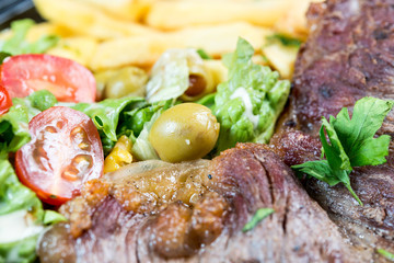 juicy steak beef meat with tomato and french fries
