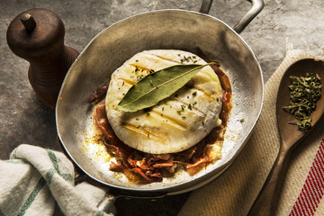 delicious italian cheese tomino with bacon grilled