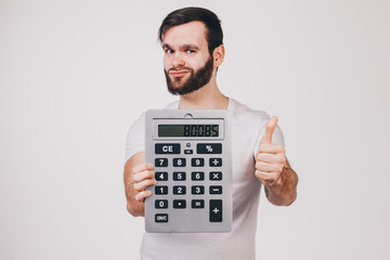 unshaved man in white t-shirt shows a big calculator