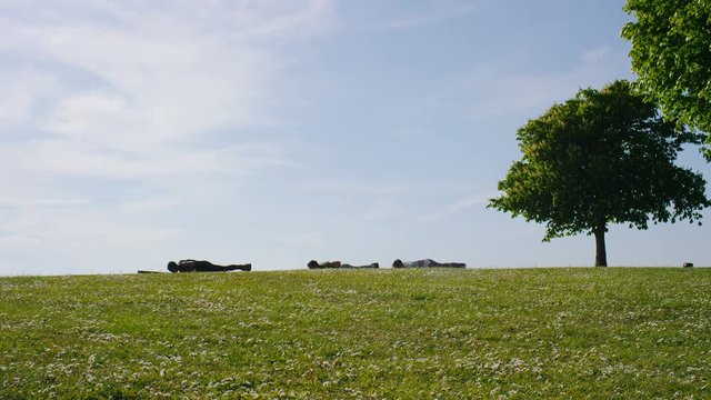 Three people doing yoga outdoors in the countryside