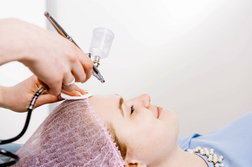 Cosmetologist performs the rejuvenation procedure