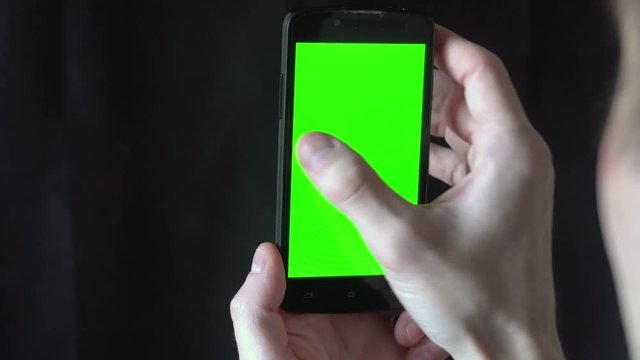 Close-up of male hands touching of smartphone. Green screen Chroma Key. Close up. Tracking motion.