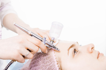 Cosmetologist performs the rejuvenation procedure