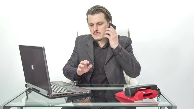 An employee didn't pick up the right phone. He is confused because he thinks that his cell phone isn't working anymore. Then he realizes that the other phone is ringing.