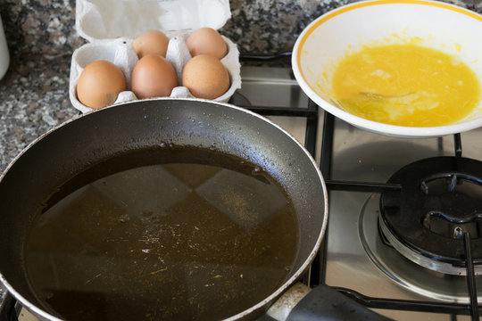preparing an omelette with beaten eggs and pan