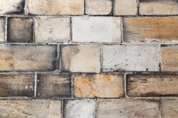 Old yellow white brick wall, close-up background