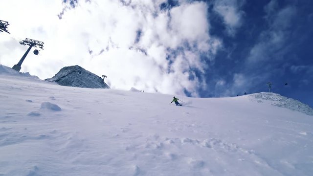 Man skiing backcountry spraying snow