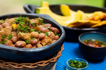 Beans with pork meat served with avocado and patacon