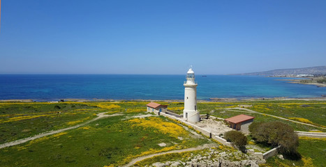 Fototapeta na wymiar Ancient lighthouse near Mediterranean Sea . Summer landscape. Cyprus.City resort. 