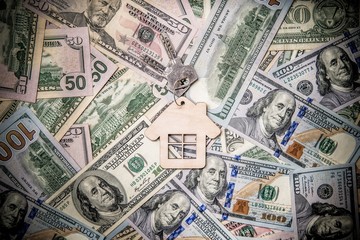 The symbol of the house lies on the background of the American currency 