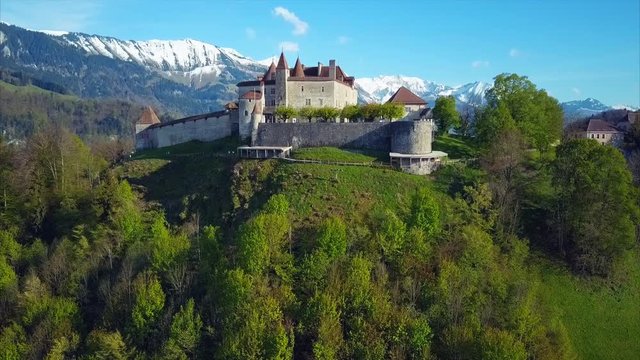 Aerial View on Gruyeres Castle in Canton of Fribourg, Switzerland, Green Forest, Blue Sky, Amazing Mountains on the Background, Summer Time