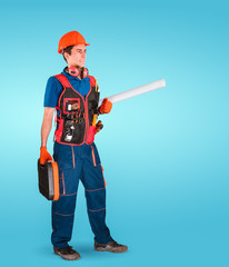 Handsome young handyman with a tool belt and tool case in hand. House renovation service. Building concept.