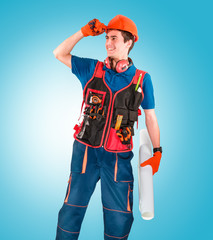 Handsome young handyman with a tool belt. House renovation service. Building concept.