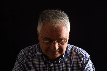 Fototapeta premium Portrait of a senior man with black background