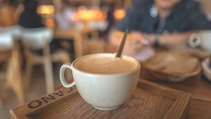 Hot Latte coffee And Spoon In Cup