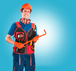 Handsome young handyman with a tool belt and scrap in hands. House renovation service. Building concept.