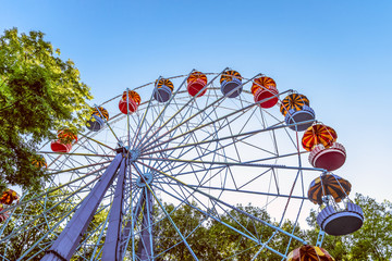 Classic Ferris wheel. Entertainment Park attraction with retro booths.