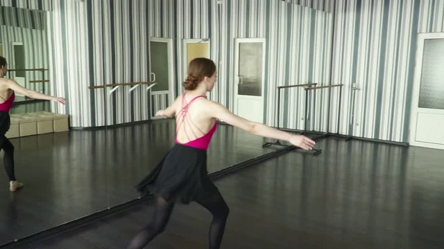 Woman making splits in the dancing studio slow motion