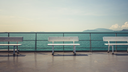 Fototapeta na wymiar White wooden bench and sea view.