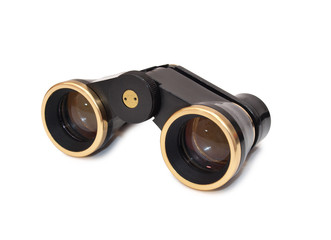 Old theatrical binoculars in a female hand on white background