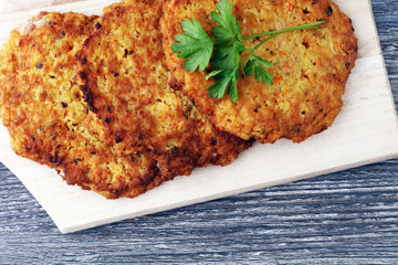 potato pancakes decorated with parsley on a cutting board on the table