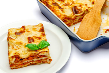 Portion of tasty lasagna isolated on white