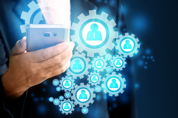lady wearing a black suit holding a mobile phone and having a wifi icon with a blue person