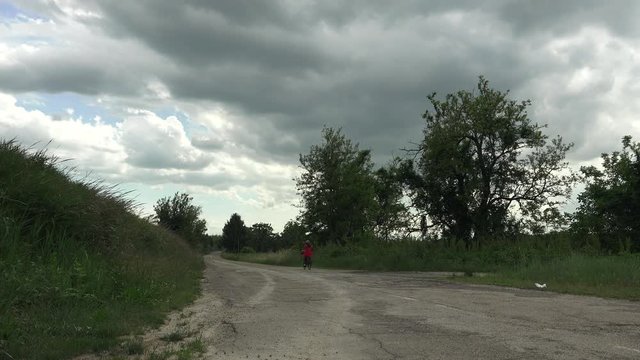 female cyclist riding on country road