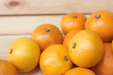 Fresh oranges from orchard on a wooden table.